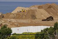 A new beachfront building is constructed in the Ajami neighborhood of Jaffa, next to a house slated to be evicted and demolished, March 2007.<br>Keren Manor/activestills.org<br>