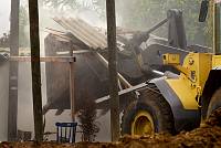 A bulldozer destroys a house in the Kfar Shalem neighborhood of Tel Aviv, after residents were forcefully evicted from their homes, with no provision of alternative housing, December 2007.<br>Oren Ziv/activestills.org<br><br><br>