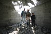 The Abas family stands on the ruins of their home in the Ras al-Amud neighborhood of East Jerusalem after the Jerusalem Municipality demolished it, January 2007. <br>Yotam Ronen/activestills.org<br><br>