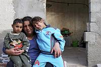 Esther Saba'a and her children outside their home in the Ajami neighborhood of Yaffo, March 2007. Though they have lived in the house since 1968, the Amidar public housing company claims they are illegal squatters.<br>Oren Ziv/activestills.org<br>