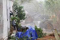 A resident of the Kfar Shalem neighborhood of Tel Aviv photographs the demolition of a house in the neighborhood, December 2007.<br>Nir Landau/activestills.org<br><br><br><br><br><br>