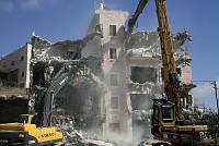 The demolition of a house in the Tzur Baher neighborhood of East Jerusalem, because the Municipality deemed it illegal, January 2007. Palestinian residents of East Jerusalem face a perpetual Catch-22 because it is virtually impossible for them to obtain building permits from the authorities, and the houses that they do build are often demolished because they are considered illegal.<br>Keren Manor/activestills.org<br>